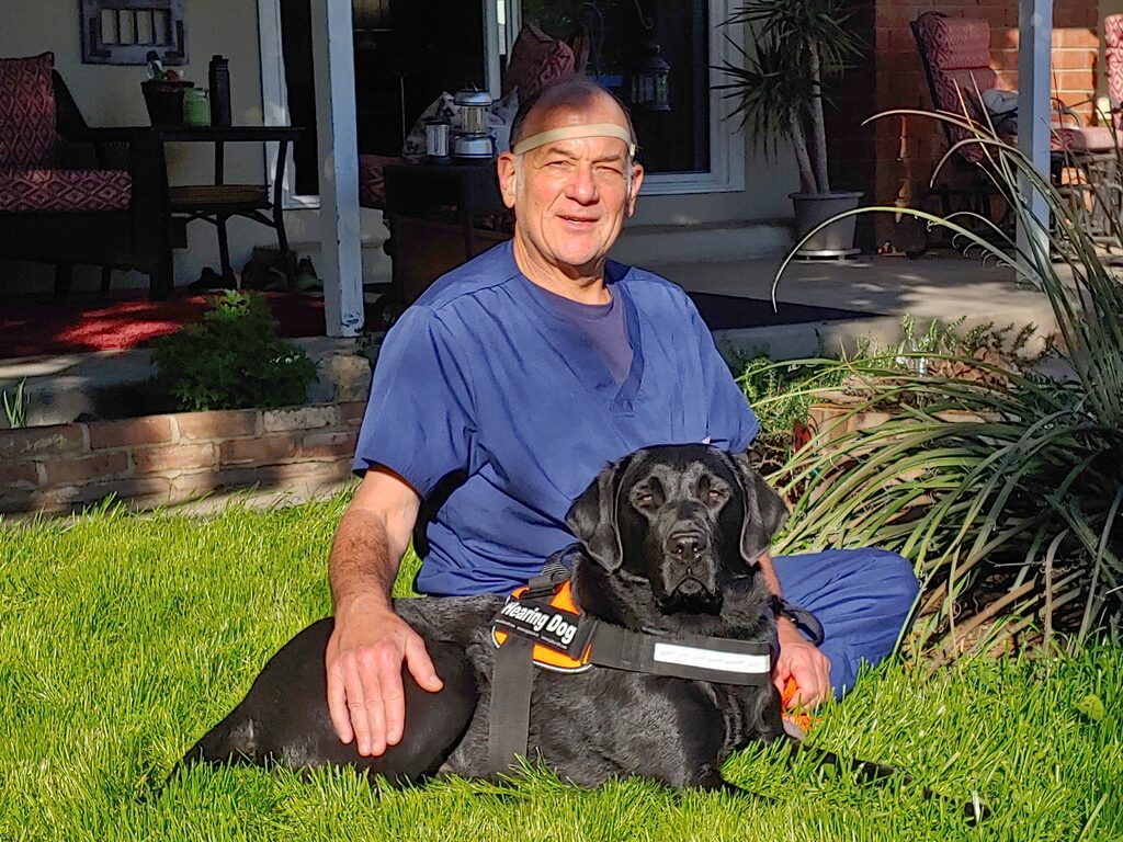 Hearing service dog assisting deaf individual in Southern Oregon community setting.

